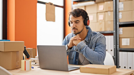 Young hispanic man ecommerce business agent having video call at office