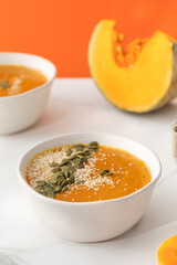 A plate with pumpkin soup puree, pumpkin and sesame seeds. Autumn menu. 