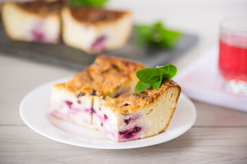 cooked cottage cheese casserole with berry filling in a plate