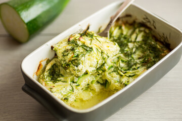 Green zucchini baked in an omelette in the oven, in a ceramic form .