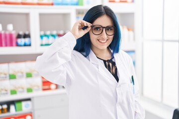 Young caucasian woman pharmacist smiling confident standing at pharmacy