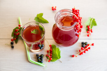fresh berry juice from red and black currant, on a wooden table