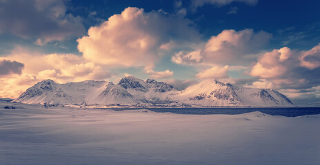 Fototapeta na wymiar Panoramic landscape - winter mountains and cloudy sky under sunlight - typical north scenery. Stunning Lofoten islands. Wonderful nature of Norway