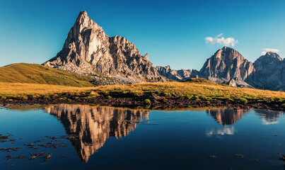 Obraz premium Amazing nature scenery. Mountains reflected in lake at sunset in autumn in Dolomites, Italy.