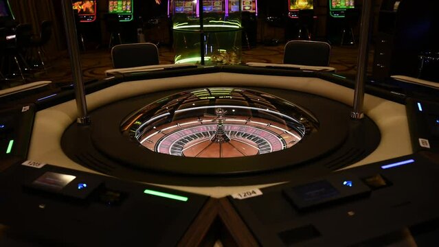 Roulette wheel at the Casino. Empty casino game room. Gambling. Close up of roulette wheel in motion. Lucky game.