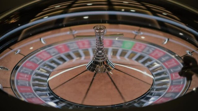 Roulette wheel at the Casino. Gambling. Close up of roulette wheel in motion. Roulette Wheel spins.