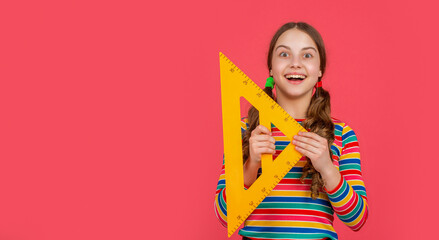 amazed school child hold math tool of triangle