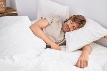 Young man lying on bed sleeping at bedroom
