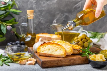 Fotobehang Bruschetta with olive oil, olives, pesto, garlic and parmesan. ciabatta bread with olive oil and spices. Delicacy. Delicious and healthy food. Vegan. Place to copy. copy space. © Avocado_studio