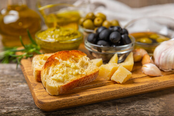 Bruschetta with olive oil, olives, pesto, garlic and parmesan. ciabatta bread with olive oil and spices. Delicacy. Delicious and healthy food. Vegan. Place to copy. copy space.