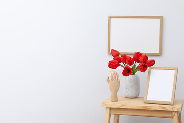 Wall and table frame with vase of flowers and figurine