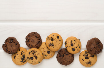 Flat lay with chocolate chip cookies on wooden background