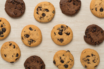 Flat lay with chocolate chip cookies on wooden background