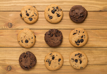Flat lay with chocolate chip cookies on wooden background