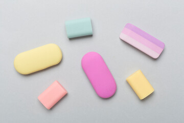 Colorful eraser on color backgroung, top view
