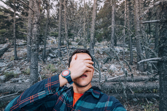 A male lone tourist man who got lost in a dense forest has a panic attack.