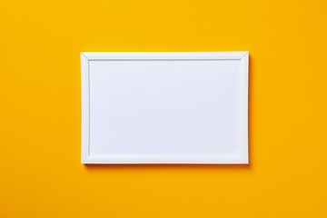 White photo frame on a yellow background