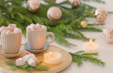 two cups of coffee with  marshmallow and christmas fir branches