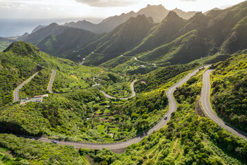 Fototapeta Aerial view of green volcanic landscape with mountain road in Tenerife obraz