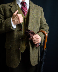 Portrait of Man in Tweed Suit Holding Umbrella. Vintage Style and Retro Fashion of English Gentleman.