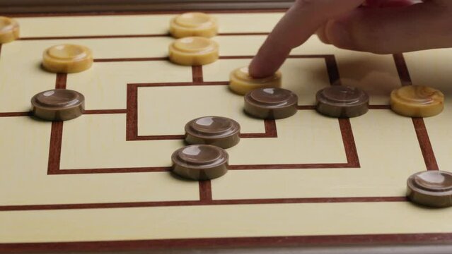 Playing Nine Men Morris Board Game