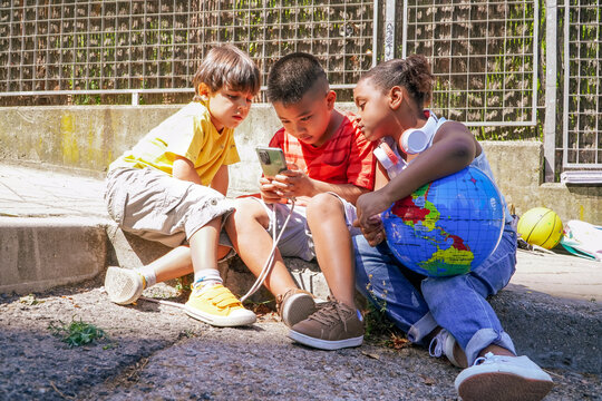 african, asian, and caucasian children learning online together