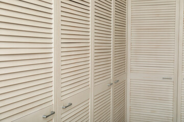 A stylish wardrobe in light colors in the apartment