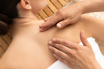 Young attractive woman in spa enjoying massage