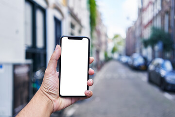 Man holding smartphone showing white blank screen at amsterdam