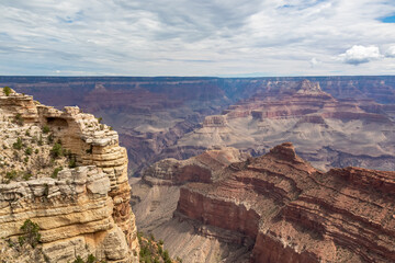 Massive rock formation with panoramic view of O Neill Butte seen from South Kaibab hiking trail at South Rim of Grand Canyon National Park, Arizona, USA. Colorado River weaving through rugged terrain