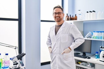 Naklejka na ściany i meble Young caucasian man scientist smiling confident standing at laboratory