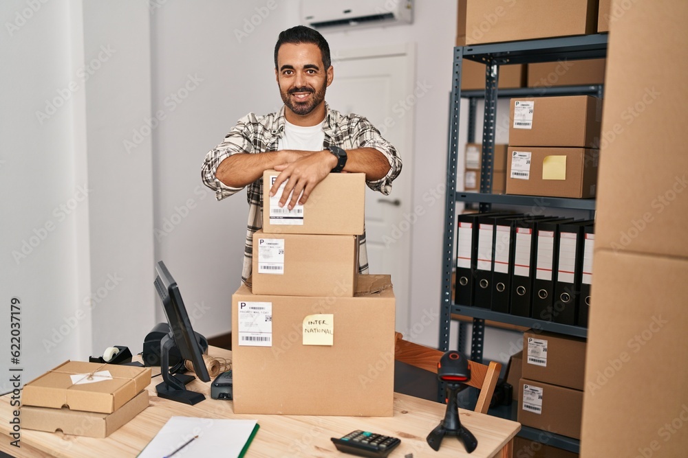 Canvas Prints Young hispanic man ecommerce business worker leaning on packages at office