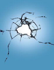 Cracks on the blue glass, a broken window after shelling. Effect of destruction during shelling