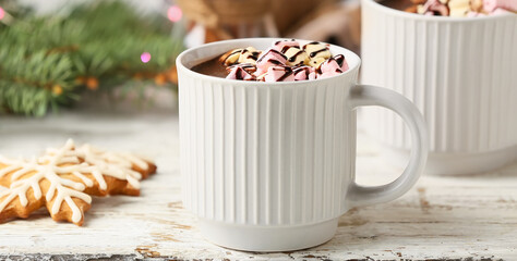 Cup of delicious hot chocolate with marshmallows on table, closeup