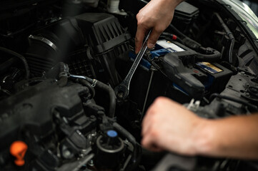 Obraz na płótnie Canvas car mechanic changing car engine