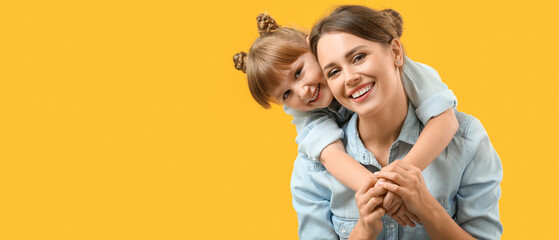 Portrait of happy mother and daughter on yellow background. Banner for design