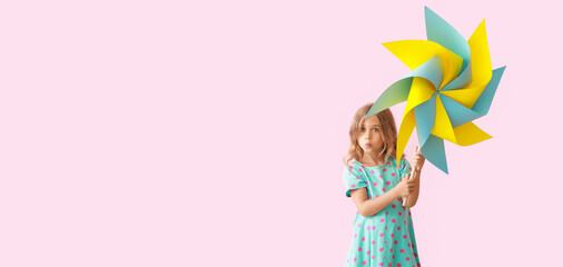 Cute little girl with paper windmill on pink background. Banner for design