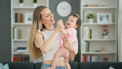 Mother and daughter hugging each other dancing at home