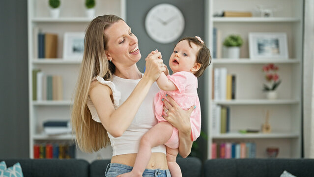 Mother And Daughter Hugging Each Other Dancing At Home