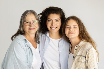 Cheerful adult, elderly women and teen girl hugging, enjoy freshness, lifestyle
