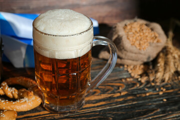 Mug of cold beer on wooden background. Oktoberfest celebration