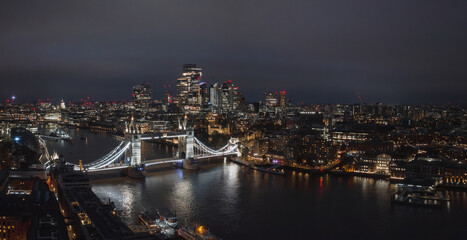 Fototapeta premium Aerial night view of the Tower Bridge in London. Beautiful illuminated panorama of London Tower Bridge.