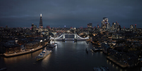 Aerial night view of the Tower Bridge in London. Beautiful illuminated panorama of London Tower Bridge at night.