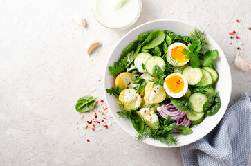 Green Buddha Bowl with Fresh Herbs and Vegetables, Healthy Balanced Meal, Bowl or Salad with Young Potatoes, Cucumber, Lettuce, Egg and Herb Dressing