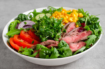 Beef steak and Fresh Vegetables Buddha Bowl, Healthy Balanced Meal on Bright Background