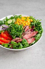 Beef steak and Fresh Vegetables Buddha Bowl, Healthy Balanced Meal on Bright Background