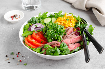 Beef steak and Fresh Vegetables Buddha Bowl, Healthy Balanced Meal on Bright Background