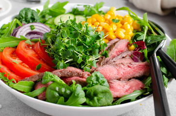 Beef steak and Fresh Vegetables Buddha Bowl, Healthy Balanced Meal on Bright Background
