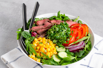 Beef steak and Fresh Vegetables Buddha Bowl, Healthy Balanced Meal on Bright Background