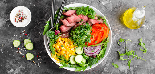 Beef steak and Fresh Vegetables Buddha Bowl, Healthy Balanced Meal on Dark Background